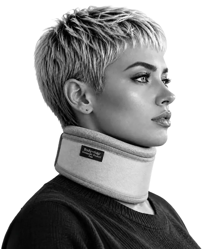 A woman wearing a Bodymap cervical collar, seated